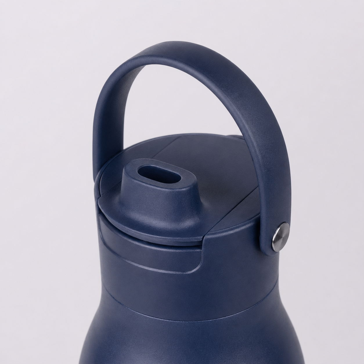 Close-up of glug bottle lid and carry handle — matte navy finish